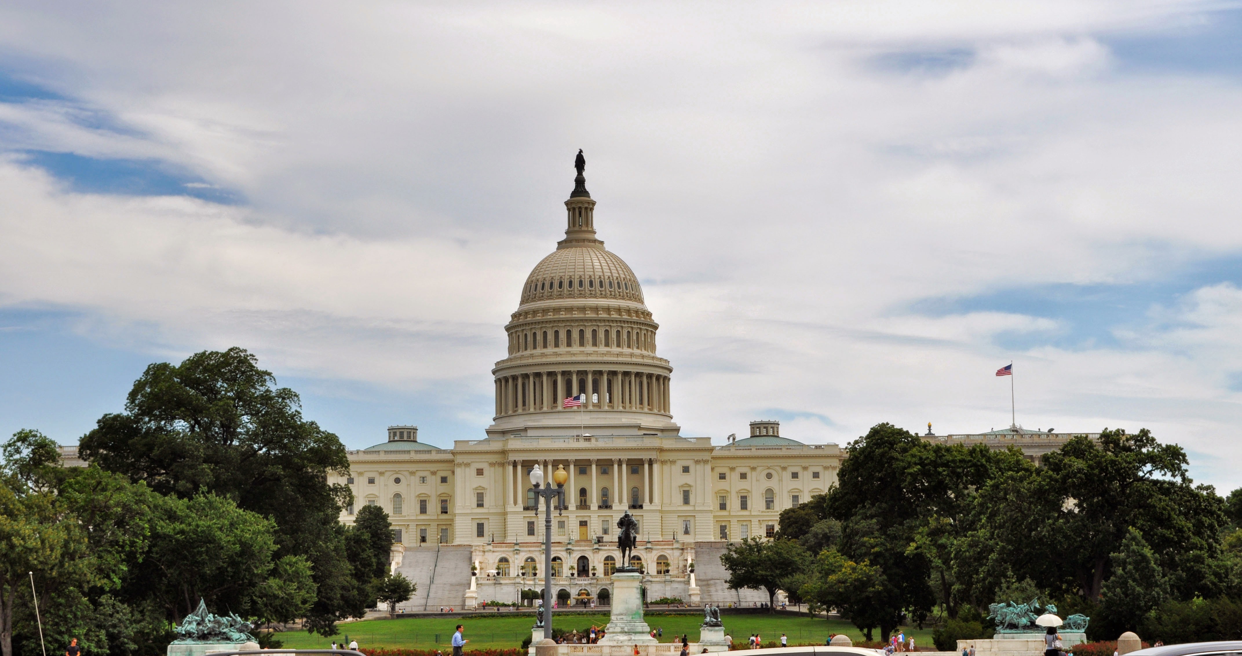 Capitol building with trees and clouds in the background