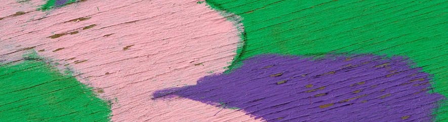 Pink, purple, and green painted on wood