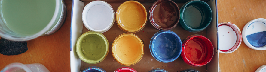 Cans of colorful paint seen from above