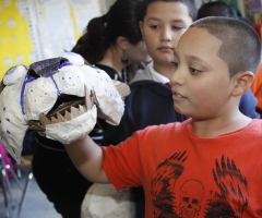 Student holding a mask