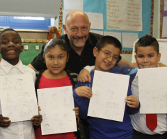 Students holding drawings with teaching artist