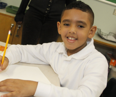 Young boy drawing in class