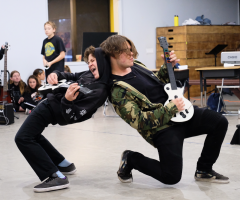 Boys rocking out with guitars