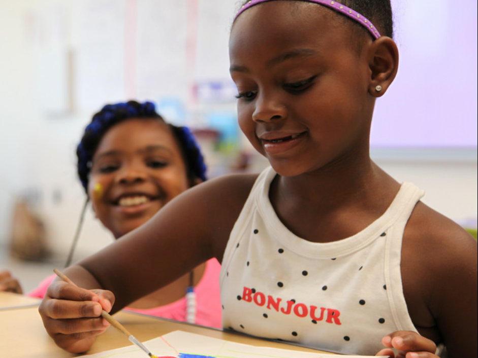 two young girls paint and draw