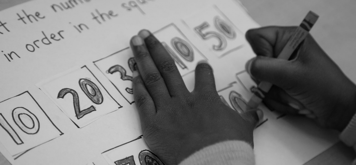 Art student's hands drawing numbers